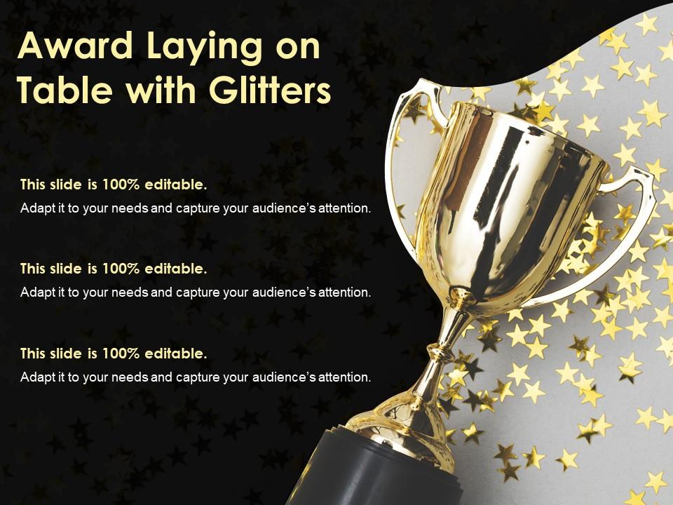 Award laying on table with glitters Slide01