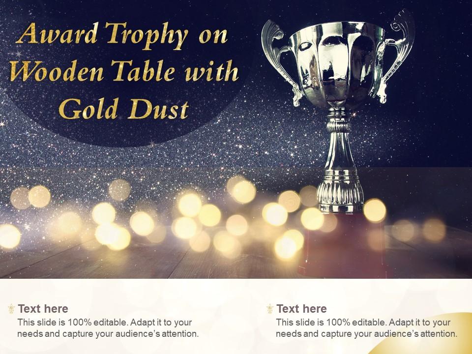 Award trophy on wooden table with gold dust Slide01