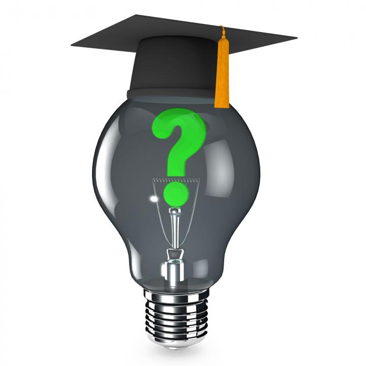 Graduation cap above bulb with green question mark stock photo Slide01