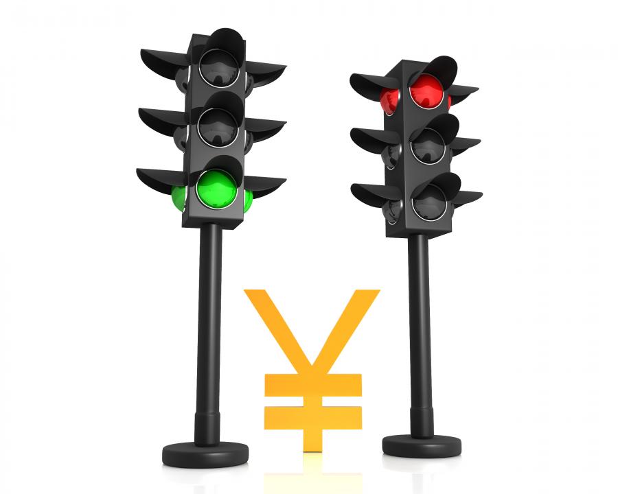 Yen symbol in between traffic lights stock photo Slide01