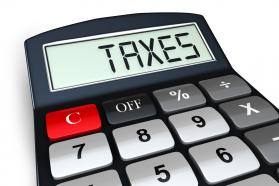 0914 Calculator With Word Taxes For Assistance With Taxes Stock Photo