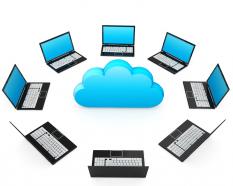 0914 network of laptops around cloud for cloud computing stock photo