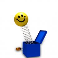 0914 smiley jumping out of cartoon box stock photo