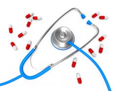 0914 stethoscope with red white medical pills stock photo