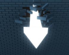 1114 an arrow breaking through a brick wall for success stock photo