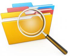 1114 magnifying glass over computer folders stock photo