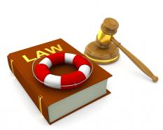 3d graphic of law book with gavel and life saving tube stock photo