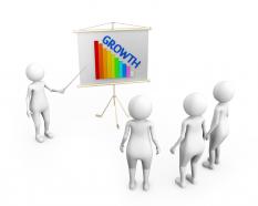 3d man showing graph bar with growth on flip chart stock photo