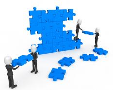 3d men working as team connecting blue puzzles completing wall task stock photo