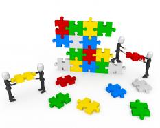 3d men working as team connecting multicolored puzzles stock photo