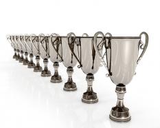 3d silver winner trophies standing in a row stock photo
