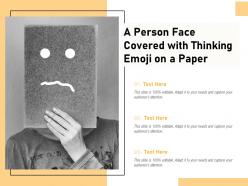 A person face covered with thinking emoji on a paper