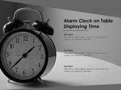 Alarm clock on table displaying time