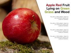 Apple red fruit lying on green grass and wood