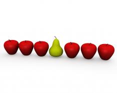 Apples in queue with one pear shows leadership stock photo