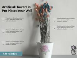 Artificial flowers in pot placed near wall