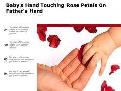 Babys hand touching rose petals on fathers hand