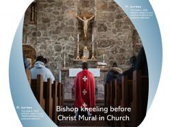 Bishop kneeling before christ mural in church