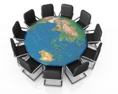 Black chairs on globe shows business meeting stock photo