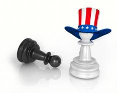 Black pawn with white pawn with hat of american flag stock photo