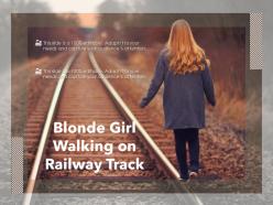 Blonde girl walking on railway track