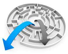 Blue and black arrows coming out of maze depicting success stock photo