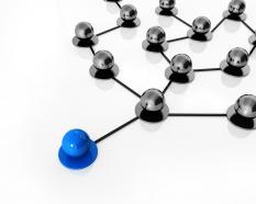 Blue ball leading black balls connected through network stock photo