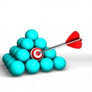 Blue balls in pyramid shape with one target ball hit by arrow stock photo