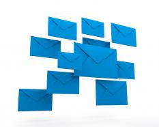 Blue colored mail envelopes with white background stock photo