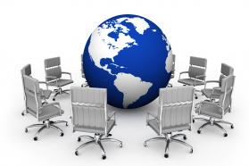 Blue globe surrounded by chairs showing team meeting stock photo