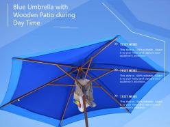 Blue umbrella with wooden patio during day time