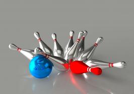 Bowling blue ball strikes red and silver pins stock photo