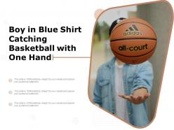 Boy in blue shirt catching basketball with one hand