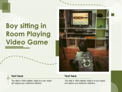 Boy sitting in room playing video game