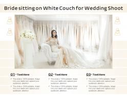 Bride sitting on white couch for wedding shoot