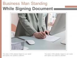 Business man standing while signing document