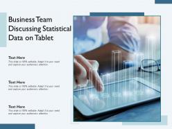 Business team discussing statistical data on tablet