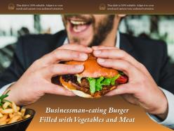 Businessman eating burger filled with vegetables and meat