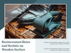 Businessman shoes and necktie on wooden surface