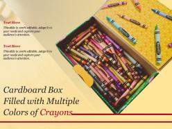 Cardboard box filled with multiple colors of crayons