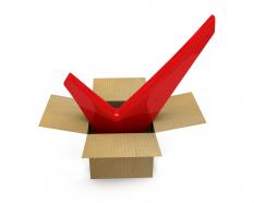 Cardboard box with red check sign inside business checklist concept stock photo