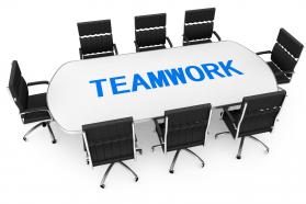 Chairs and table for team meeting along with word teamwork stock photo