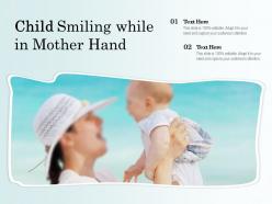 Child smiling while in mother hand
