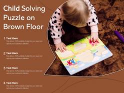 Child solving puzzle on brown floor