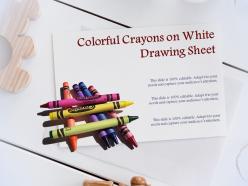 Colorful crayons on white drawing sheet