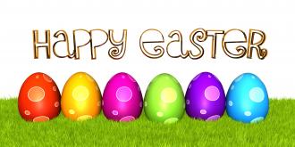 Colorful eggs on grass with happy easter message stock photo