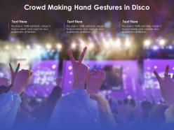 Crowd making hand gestures in disco