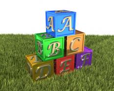 Cubes of colorful letters on grass stock photo