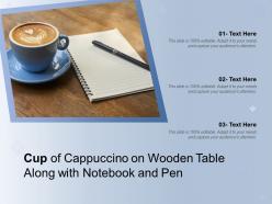 Cup of cappuccino on wooden table along with notebook and pen