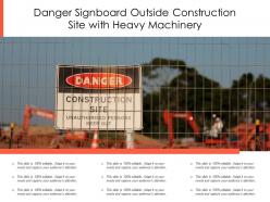 Danger signboard outside construction site with heavy machinery